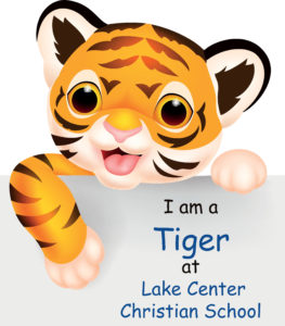 Tiger Cub Holding a "I am a Tiger at Lake Center Christian School" Sign