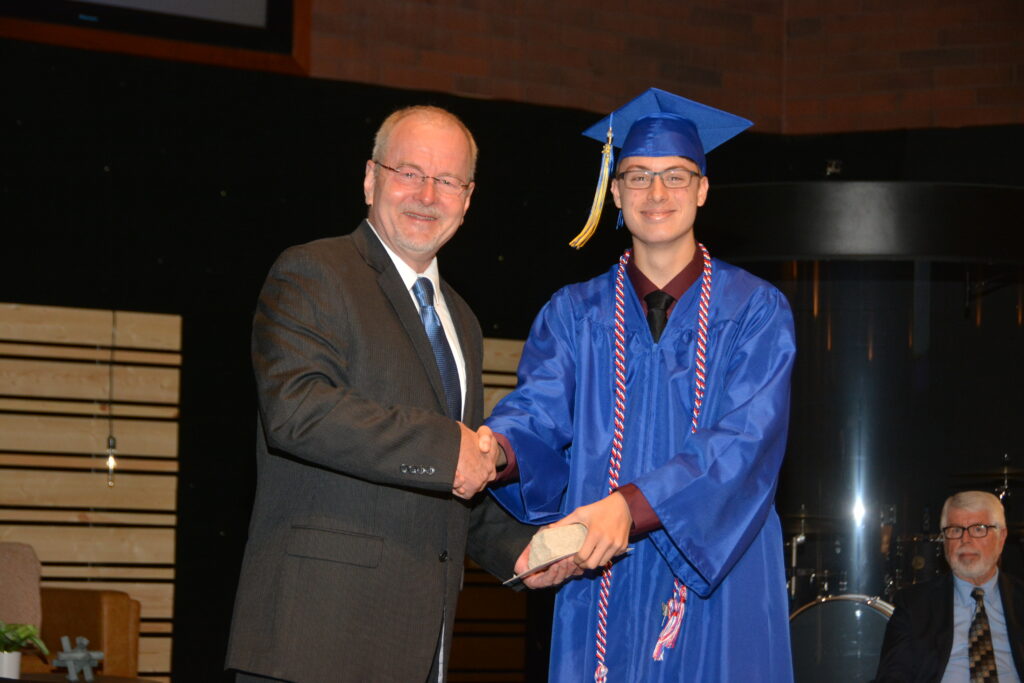 Class of 2023 Chaplain Josh Hornyak receives the Living Stone Award from Mr. Jeff Knori for boldly living for the cause of Christ.