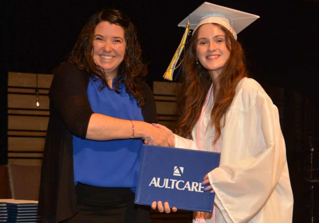 Lake Center Secondary Principal Mrs. Crystal Maarschalk presents the Aultcare Scholarship to Faith Varga