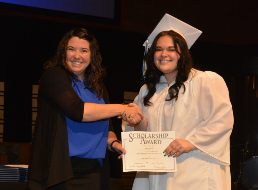 Lake Center Secondary Principal Mrs. Crystal Maarschalk presents the Joan Landow Jost Memorial Scholarship for Visual Arts to Kendell Wiff