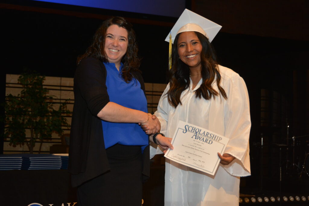 Lake Center Secondary Principal Mrs. Crystal Maarschalk presents the LCCS Blue & Gold Athletic Booster Club Scholarship to Leah Starcher